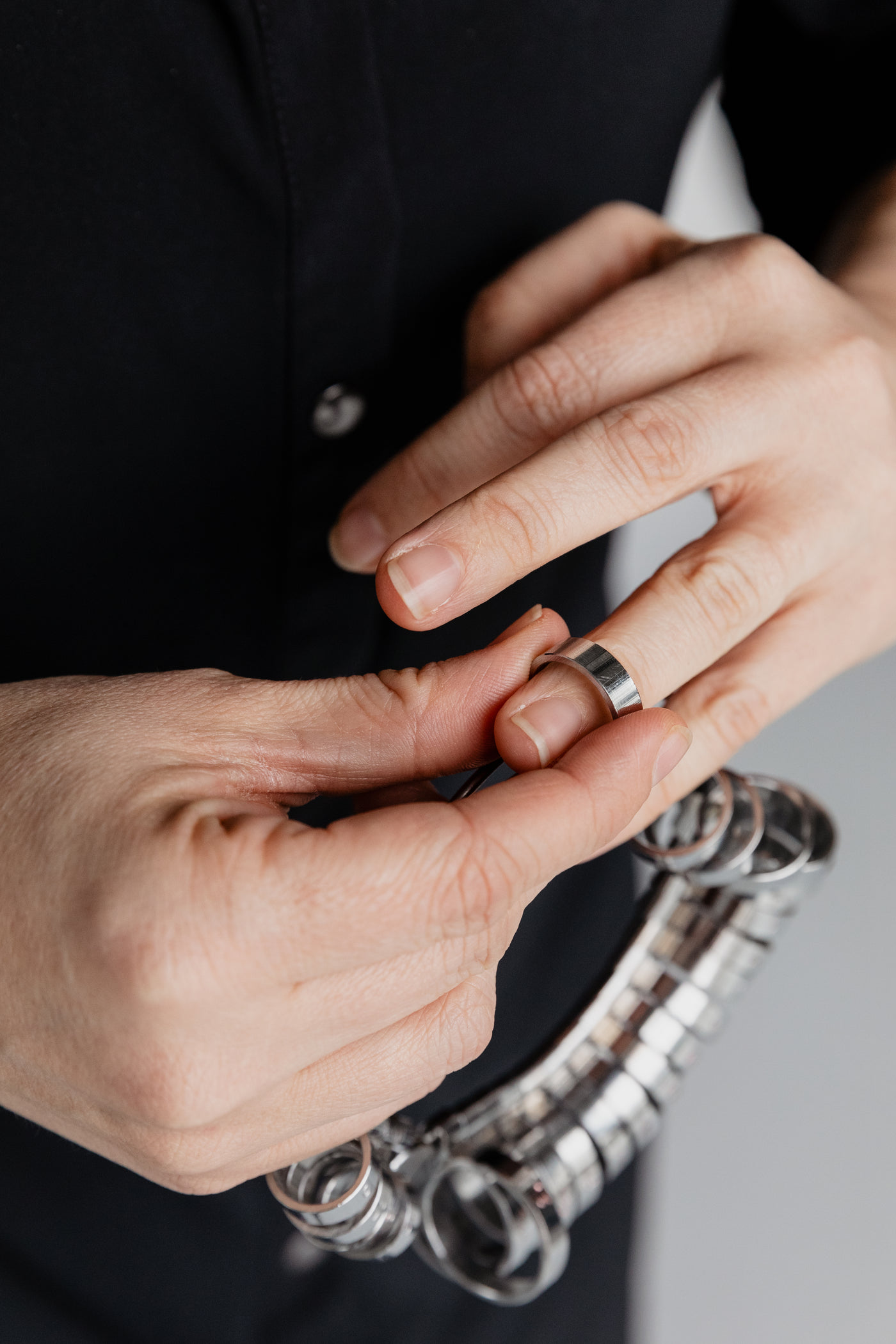 Two hands adjusting a ring, close up
