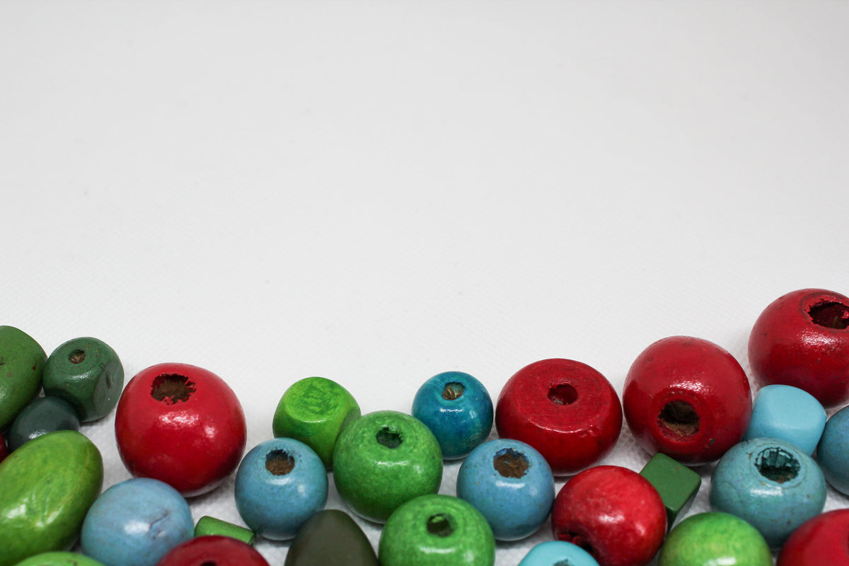 Painted wooden beads in red, green and blue arranged in rows